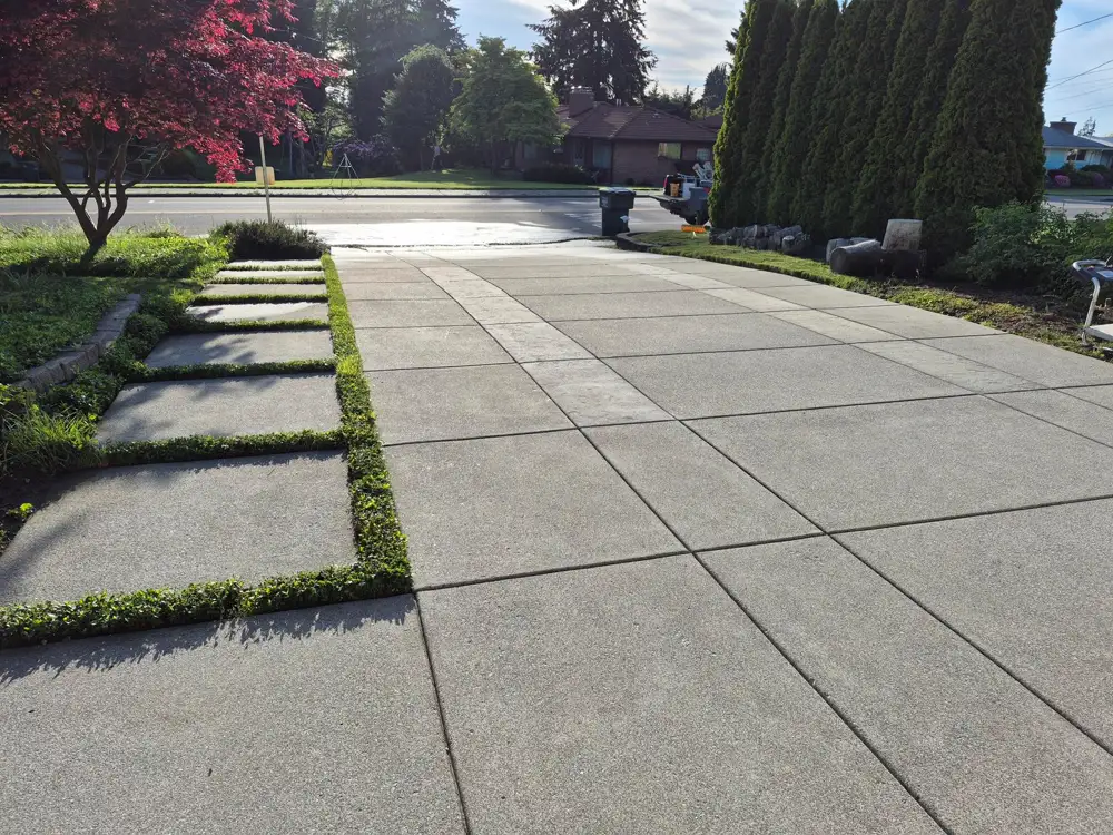 Stone walkway beside manicured garden beds after pressure washing