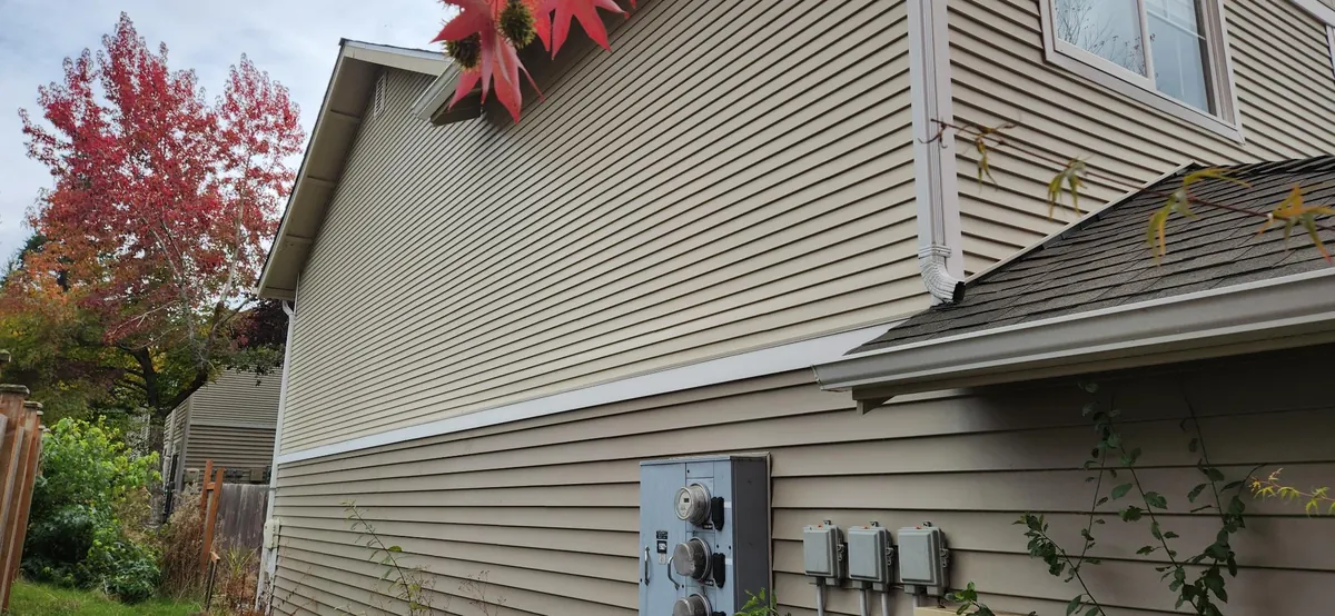 The same beige lap siding wall uniform and clean after washing