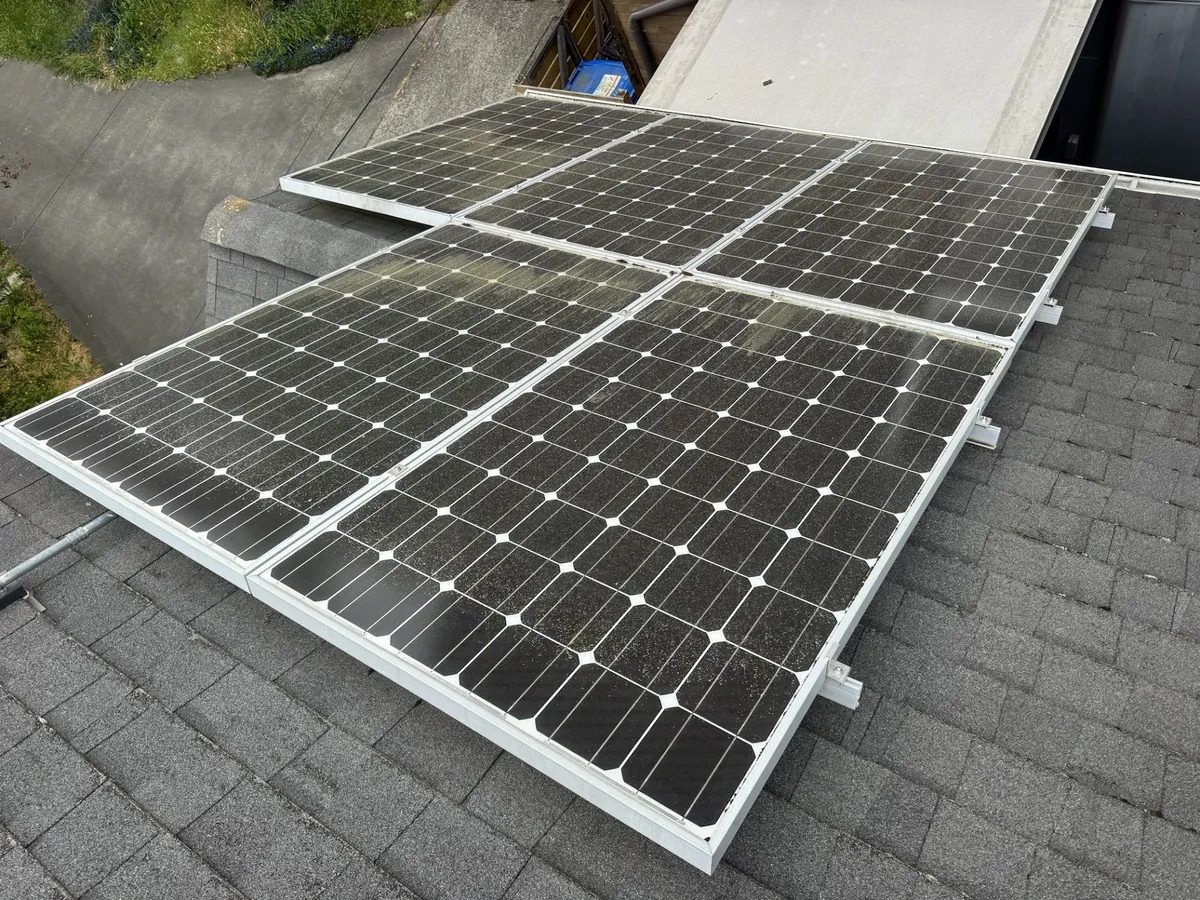 Roof mounted solar panels with a dusty hazy film on the glass before cleaning